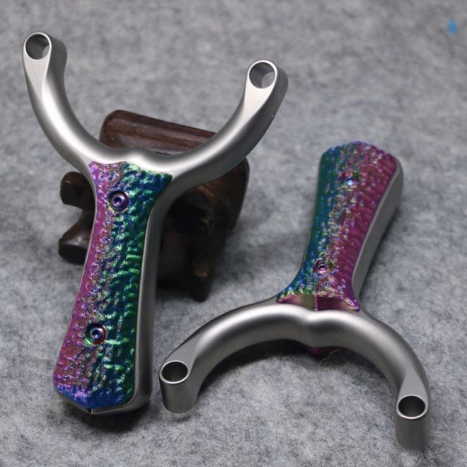 Compact Sea Wave-X27 titanium alloy slingshot with G10 inlays for comfort and reduced hand fatigue during long shooting sessions.