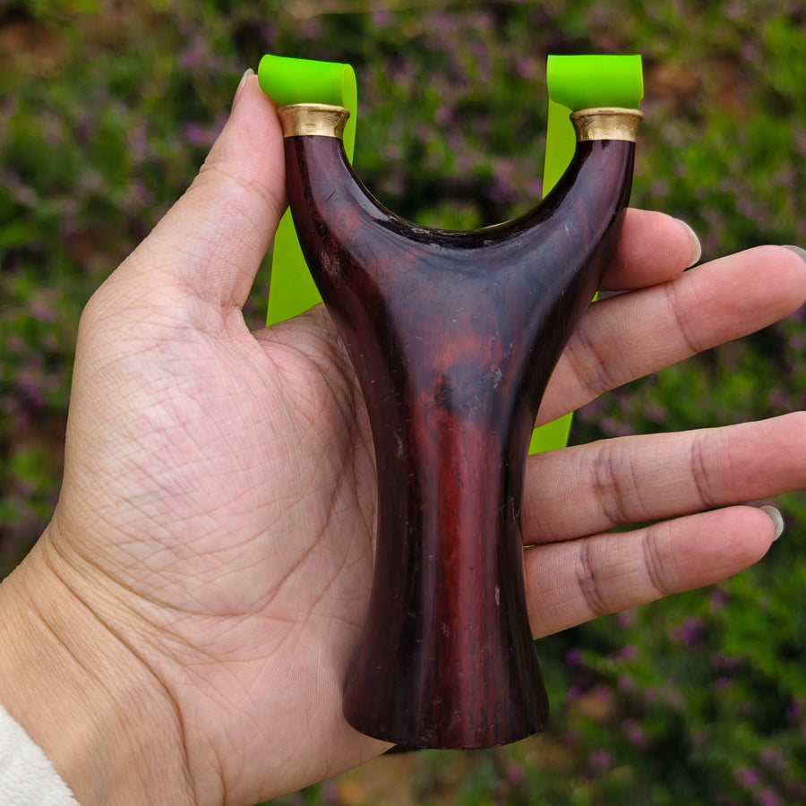 Lucky charm rosewood slingshot symbolizing protection and joy for outdoor shooting activities.