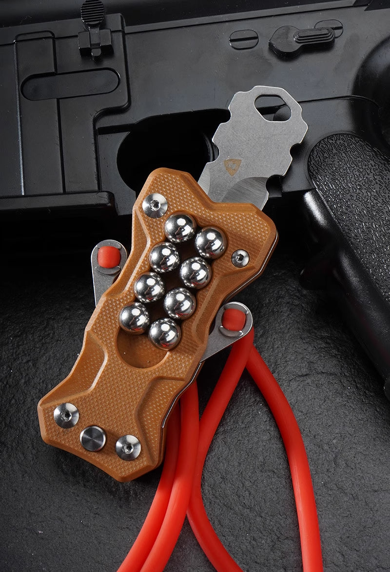 Compact carry TitanShot-X24 stainless steel slingshot ideal for camping, backpacking, and outdoor survival gear setups.