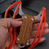 Rugged TitanShot-X24 stainless steel slingshot for precision shooting, designed for adventurers, hunters, and tactical operators.