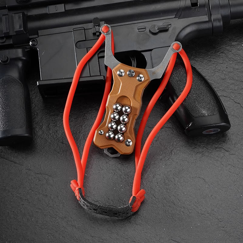 Triple-function TitanShot-X24 outdoor survival tool combining slingshot power, sharp folding knife, and glass breaker tip in one.