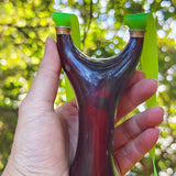 Natural rosewood slingshot featuring hand-polished craftsmanship and ergonomic grip for precision.