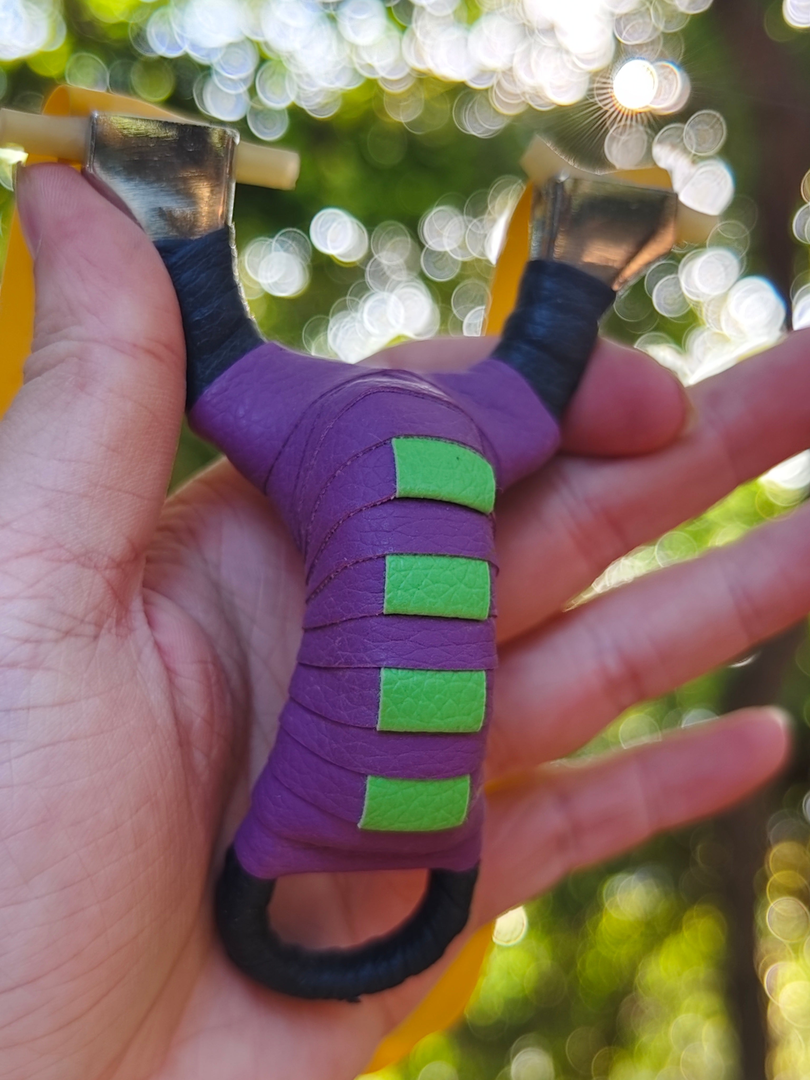 Pocket Snipe X13 compact stainless steel slingshot with purple and black finish for precise, accurate shooting.