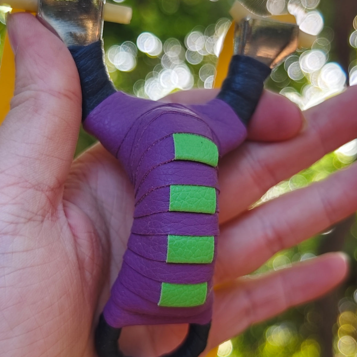 Pocket Snipe X13 compact stainless steel slingshot with purple and black finish for precise, accurate shooting.
