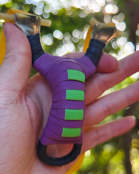 Pocket Snipe X13 compact stainless steel slingshot with purple and black finish for precise, accurate shooting.